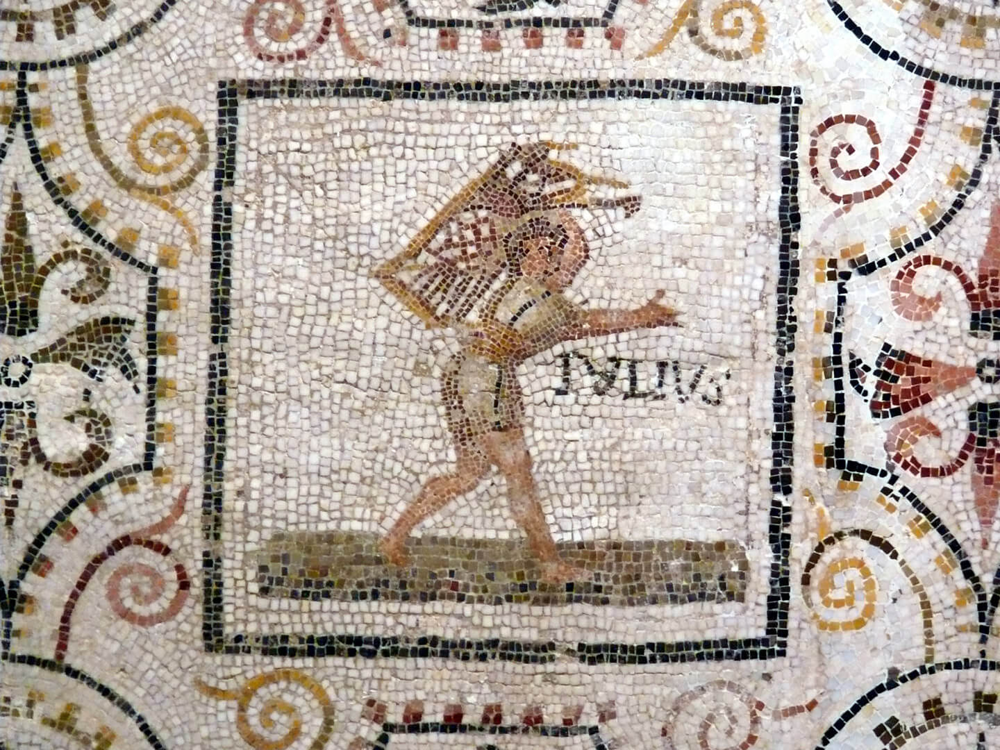 ‘Iulius’ on the mosaic with the Months from Thysdrus (El Djem). Archaeological Museum of Sousse, Tunisia, 3rd century AD. A male figure carries a bundle, perhaps sheaves of wheat or tools for the harvest.